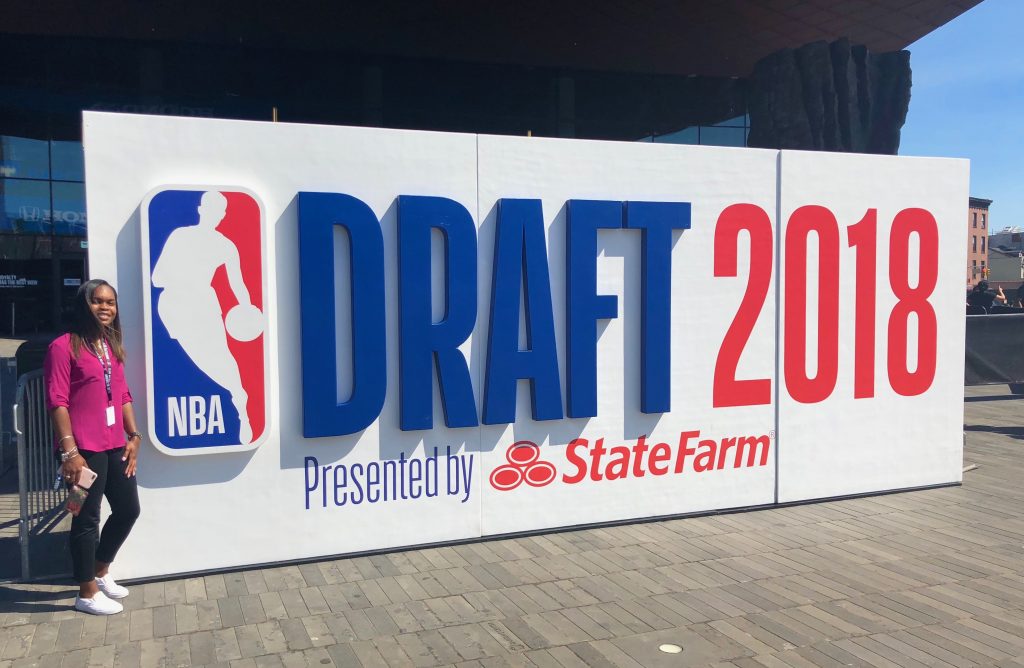 Autumnsarah Foster-Pagett in front of the DRAFT 2018 sign